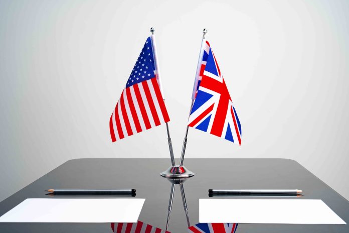 Flags of USA and United Kingdom on negotiation table
